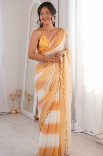 Mustard tissue satin striped saree with unstitched blouse piece.