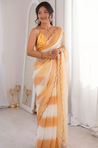 Mustard tissue satin striped saree with unstitched blouse piece.