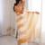 Mustard tissue satin striped saree with unstitched blouse piece.