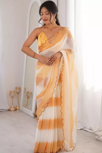 Mustard tissue satin striped saree with unstitched blouse piece.