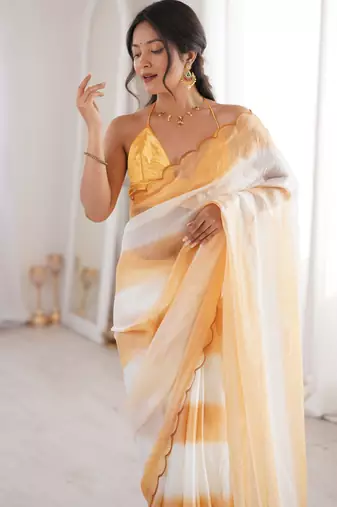 Mustard tissue satin striped saree with unstitched blouse piece.
