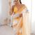 Mustard tissue satin striped saree with unstitched blouse piece.