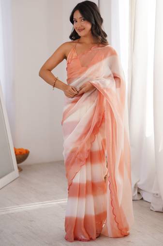 Peach tissue satin striped saree with unstitched blouse piece.
