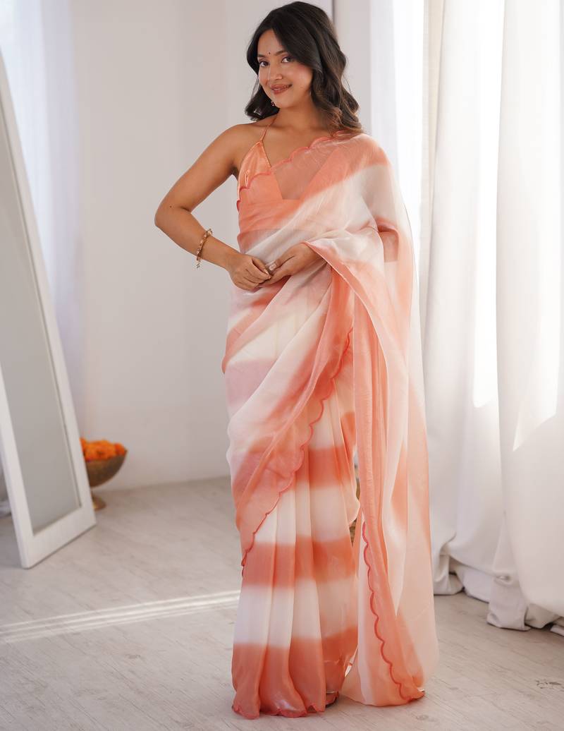 Peach tissue satin striped saree with unstitched blouse piece.