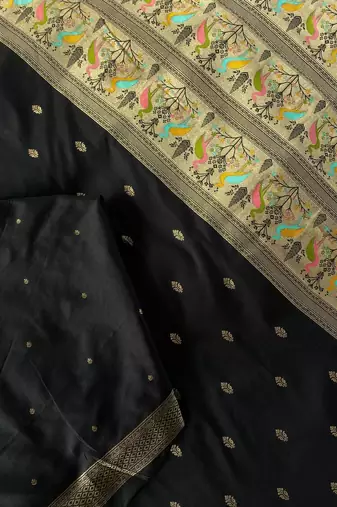 black color ilver zari chaap weaving buttis and a matching border completing silk blend saree