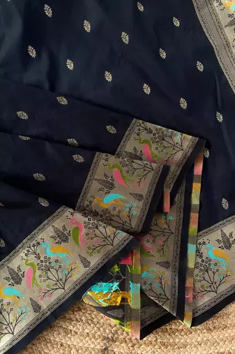 black color ilver zari chaap weaving buttis and a matching border completing silk blend saree