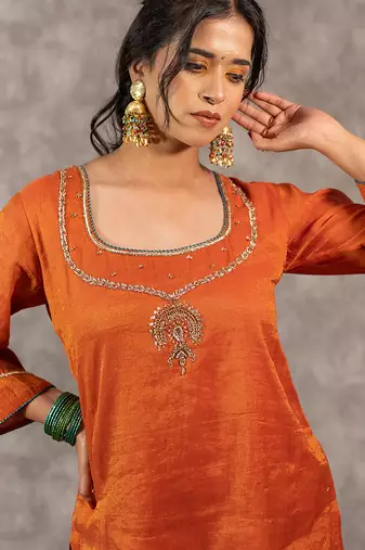 Orange tissue chnaderi kurta set with contrast salwar and matching dupatta, stitched