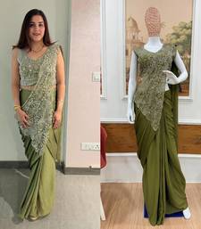 Olive green embroidered saree with intricate silver zari work
