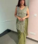 Olive green embroidered saree with intricate silver zari work