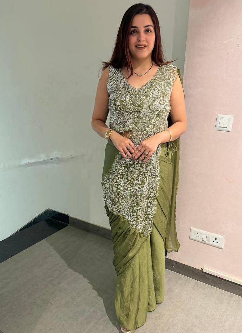 Olive green embroidered saree with intricate silver zari work