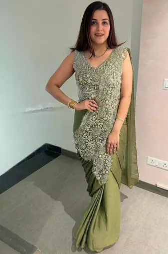 Olive green embroidered saree with intricate silver zari work
