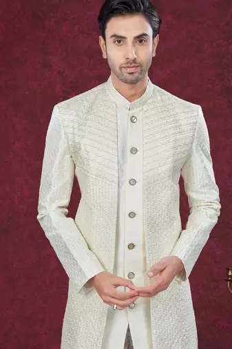Cream embroidered indo-western sherwani set with thread, stone & fancy button work.