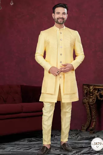 Yellow embroidered jacket attached indo-western sherwani set with thread, stone & fancy button work.