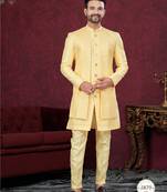 Yellow embroidered jacket attached indo-western sherwani set with thread, stone & fancy button work.