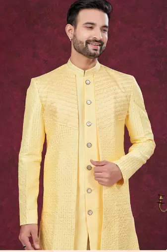Yellow embroidered jacket attached indo-western sherwani set with thread, stone & fancy button work.