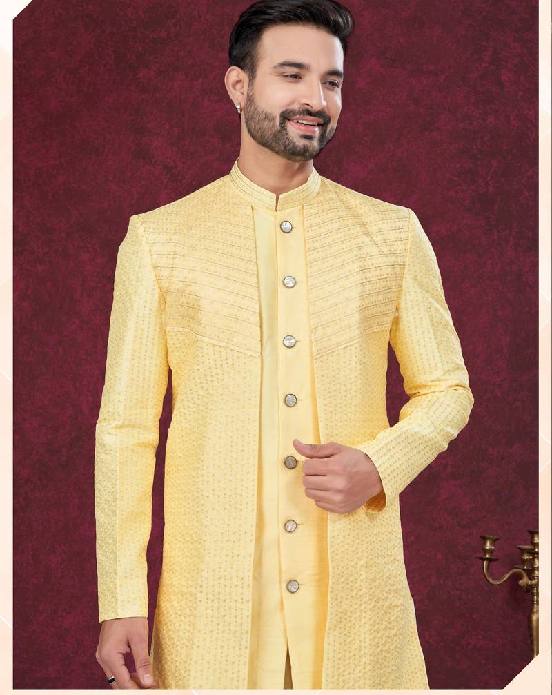 Yellow embroidered jacket attached indo-western sherwani set with thread, stone & fancy button work.