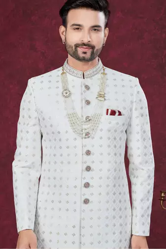 Off white embroidered jacket attached indo-western sherwani set with thread, stone & fancy button work.