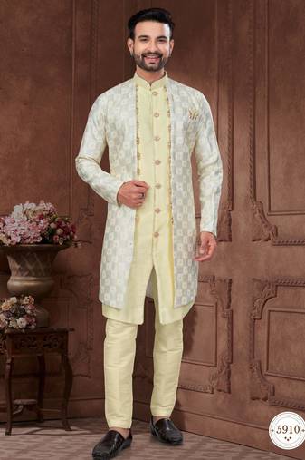 Light yellow embroidered jacket attached indo-western sherwani set with thread, stone & fancy button work.