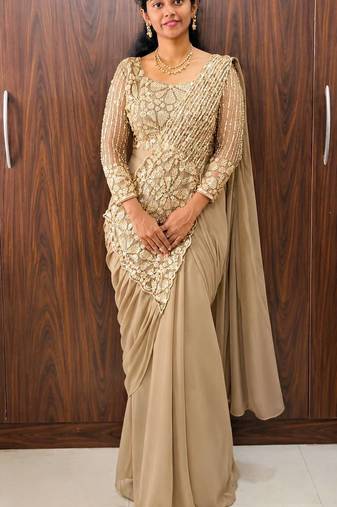 Cream embroidered pre-draped saree with designer blouse