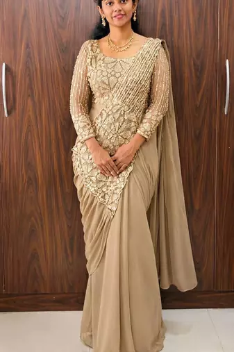 Cream embroidered pre-draped saree with designer blouse