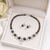Black pearl & cubic zirconia necklace & earrings set floral cz design, pear drop pendant, matching earrings.