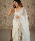 Cream net embellished saree with unstitched blouse piece.