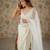 Cream net embellished saree with unstitched blouse piece.