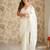Cream net embellished saree with unstitched blouse piece.