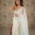 Cream net embellished saree with unstitched blouse piece.