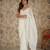 Cream net embellished saree with unstitched blouse piece.