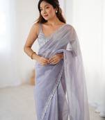 Lilac net embellished saree with unstitched blouse piece.