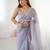 Lilac net embellished saree with unstitched blouse piece.
