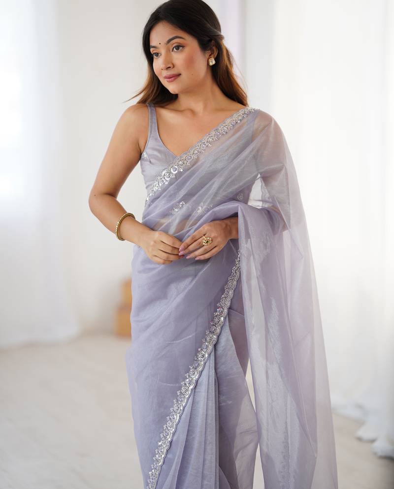 Lilac net embellished saree with unstitched blouse piece.