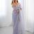 Lilac net embellished saree with unstitched blouse piece.