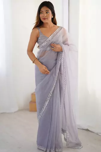 Lilac net embellished saree with unstitched blouse piece.