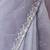Lilac net embellished saree with unstitched blouse piece.