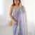 Lilac net embellished saree with unstitched blouse piece.