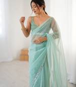 Mint net embellished saree with unstitched blouse piece.