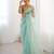 Mint net embellished saree with unstitched blouse piece.