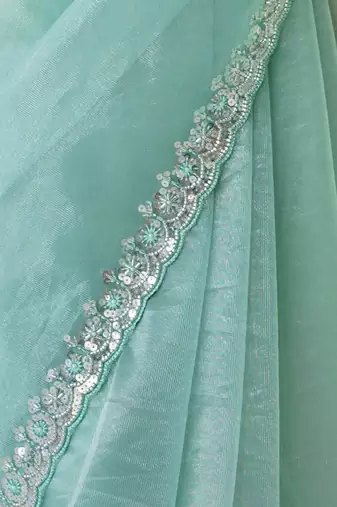 Mint net embellished saree with unstitched blouse piece.