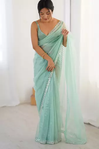 Mint net embellished saree with unstitched blouse piece.