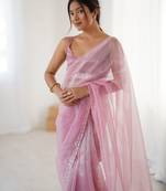 Pink net embellished saree with unstitched blouse piece.