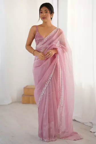 Pink net embellished saree with unstitched blouse piece.