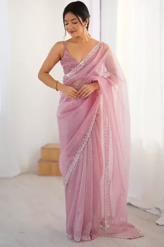 Pink net embellished saree with unstitched blouse piece.
