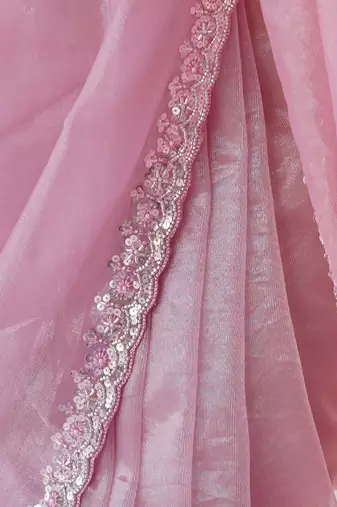 Pink net embellished saree with unstitched blouse piece.