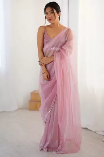 Pink net embellished saree with unstitched blouse piece.