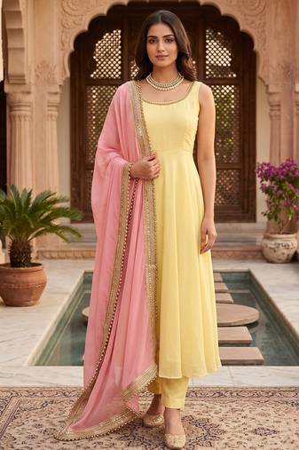 Women yellow anarkali kurta with yellow pant and pink dupatta