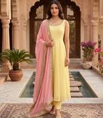 Women yellow anarkali kurta with yellow pant and pink dupatta