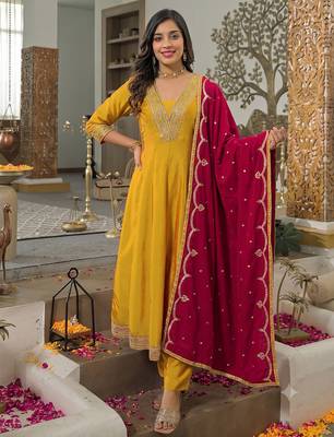 Women’s mustard yellow embroidered long flared kurta pant set with contrast pink border work dupatta 1