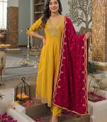 Women’s mustard yellow embroidered long flared kurta pant set with contrast pink border work dupatta